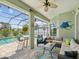 Cozy screened-in patio featuring comfortable seating, fish decorations, and pool views at 2730 River Woods Dr, Parrish, FL 34219