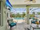 Relaxing screened-in patio with views of the pool, seating area, and tropical decor at 2730 River Woods Dr, Parrish, FL 34219