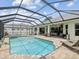 A beautiful in-ground pool with screened-in enclosure and brick paver deck at 2730 River Woods Dr, Parrish, FL 34219