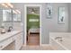 A glimpse of the bedroom from the bathroom, showcasing the sink, tub, and bedroom layout at 30445 Tremont Dr, Wesley Chapel, FL 33543