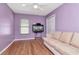 Cozy bedroom with wood laminate flooring, a ceiling fan, and lots of natural light at 30445 Tremont Dr, Wesley Chapel, FL 33543