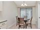 Cozy dining area with a round table, four chairs, and a large window for natural light at 30445 Tremont Dr, Wesley Chapel, FL 33543