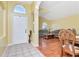 Inviting foyer with tile flooring leads into a living room with hardwood floors, exuding warmth and sophistication at 30445 Tremont Dr, Wesley Chapel, FL 33543