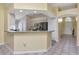 Kitchen with bar-top counter, stainless steel appliances, and a view to the front entry at 30445 Tremont Dr, Wesley Chapel, FL 33543