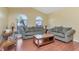 Comfortable living room with hardwood floors and large windows, ideal for relaxing and entertaining guests at 30445 Tremont Dr, Wesley Chapel, FL 33543