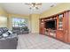 Bright living room with tile flooring, large window, and an entertainment center for a cozy atmosphere at 30445 Tremont Dr, Wesley Chapel, FL 33543