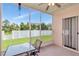 Screened-in patio with a ceiling fan, tiled floor, and a view of the fenced-in backyard at 30445 Tremont Dr, Wesley Chapel, FL 33543