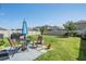 Backyard featuring patio seating, an umbrella and a grill at 30989 Summer Sun Loop, Wesley Chapel, FL 33545