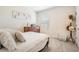 Bright bedroom featuring neutral walls, white linens and a wood dresser next to a window at 30989 Summer Sun Loop, Wesley Chapel, FL 33545