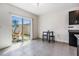 Bright dining area featuring tiled flooring, an outdoor patio view, and access to the kitchen at 30989 Summer Sun Loop, Wesley Chapel, FL 33545