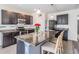Elegant kitchen island with granite countertops, stainless steel appliances, and dark cabinets at 30989 Summer Sun Loop, Wesley Chapel, FL 33545