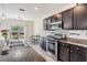 Stylish kitchen with stainless steel appliances, granite countertops, and backyard view at 30989 Summer Sun Loop, Wesley Chapel, FL 33545