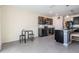Well-equipped kitchen with dark cabinets, stainless steel appliances, island seating, and a dining nook at 30989 Summer Sun Loop, Wesley Chapel, FL 33545