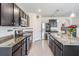 Modern kitchen with granite countertops, stainless steel appliances, and sleek dark cabinetry at 30989 Summer Sun Loop, Wesley Chapel, FL 33545