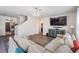 Spacious living room with hardwood floors, neutral walls, comfortable seating, and an open staircase at 30989 Summer Sun Loop, Wesley Chapel, FL 33545