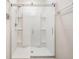 Modern glass enclosed shower with built in shelving, handheld sprayer, and bench at 30989 Summer Sun Loop, Wesley Chapel, FL 33545