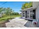 Backyard featuring a large concrete patio that connects the house to a tree lined yard at 3100 70Th N St, St Petersburg, FL 33710