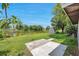 Landscaped backyard featuring lush green grass, a small lake, and a shed at 3100 70Th N St, St Petersburg, FL 33710