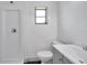 This bathroom offers a shower, toilet, and vanity with a sink and a window for natural light at 3100 70Th N St, St Petersburg, FL 33710