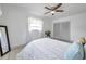 Cozy bedroom featuring a ceiling fan, window, and closet with sliding doors at 3100 70Th N St, St Petersburg, FL 33710