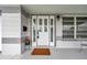 Front door featuring a decorative glass, sidelights and a modern light fixture at 3100 70Th N St, St Petersburg, FL 33710