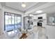 Modern kitchen featuring white cabinets, stainless steel appliances, and a glass-top dining table at 3100 70Th N St, St Petersburg, FL 33710