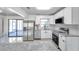 Modern kitchen featuring stainless steel appliances, white cabinets, and stone countertops at 3100 70Th N St, St Petersburg, FL 33710
