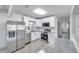 Updated kitchen with white cabinets, stainless steel appliances, and granite countertops at 3100 70Th N St, St Petersburg, FL 33710