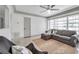 Comfortable living room with a sectional sofa, ceiling fan, and bright windows for natural light at 3100 70Th N St, St Petersburg, FL 33710