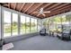 Relaxing sunroom featuring a ceiling fan, two chairs, and multiple windows offering views of the outdoors at 3100 70Th N St, St Petersburg, FL 33710