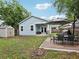 Charming backyard with a patio, dining set, shed, and well-maintained lawn at 311 W Ida St, Tampa, FL 33603