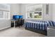 Bright bedroom features a desk, dual monitors, and a cozy bed by a sunlit window at 311 W Ida St, Tampa, FL 33603