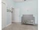 Bedroom with a crib and soft blue walls, providing a comforting space for a little one at 311 W Ida St, Tampa, FL 33603
