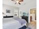 Light-filled bedroom featuring neutral walls, a ceiling fan, and a view into the en-suite bathroom at 311 W Ida St, Tampa, FL 33603