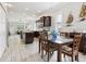 Charming dining room adjacent to the kitchen with wood floors and dark wood cabinets at 311 W Ida St, Tampa, FL 33603