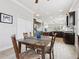 Charming dining room adjacent to the kitchen with wood floors and dark wood cabinets at 311 W Ida St, Tampa, FL 33603