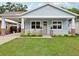 Charming single-story home featuring a inviting front porch and a well-manicured lawn at 311 W Ida St, Tampa, FL 33603