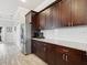 Kitchen area showcasing dark wood cabinets, stainless steel refrigerator, and white subway tile backsplash at 311 W Ida St, Tampa, FL 33603