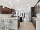 Spacious kitchen with dark wood cabinetry, granite countertops, and an island with bar seating at 311 W Ida St, Tampa, FL 33603