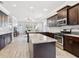 Bright, open kitchen featuring dark wood cabinets, stainless steel appliances, and granite countertops at 311 W Ida St, Tampa, FL 33603