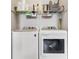 Functional laundry room with modern washer and dryer and ample shelving for storage at 311 W Ida St, Tampa, FL 33603