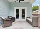 Covered patio with comfortable seating and ceiling fan, perfect for outdoor relaxation at 311 W Ida St, Tampa, FL 33603