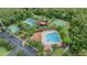An aerial view of a community pool and tennis courts nestled in a lush, green surrounding at 31331 Anniston Dr, Wesley Chapel, FL 33543