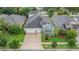 Aerial shot of home showing the three car garage, landscaping and community at 31331 Anniston Dr, Wesley Chapel, FL 33543