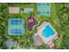 An aerial view showcases a pool, tennis courts, and sports complex within the community at 31331 Anniston Dr, Wesley Chapel, FL 33543