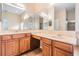 Primary bathroom features a double sink vanity, large mirror and tile flooring at 31331 Anniston Dr, Wesley Chapel, FL 33543