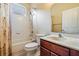 Bathroom with a shower and tub, vanity, and toilet with a dark wood cabinet at 31331 Anniston Dr, Wesley Chapel, FL 33543