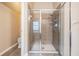 Bathroom features glass shower, neutral tile, and a separate water closet at 31331 Anniston Dr, Wesley Chapel, FL 33543