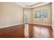 Empty bedroom boasts wood flooring, a tray ceiling, and a bright window for natural light at 31331 Anniston Dr, Wesley Chapel, FL 33543