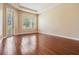Spacious bedroom with wood flooring, a tray ceiling, and a bright window for natural light at 31331 Anniston Dr, Wesley Chapel, FL 33543